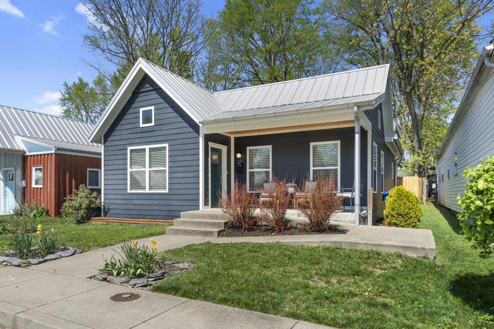 Renovated older cottage with a standing-seam metal roof and covered porch in Lexington KY