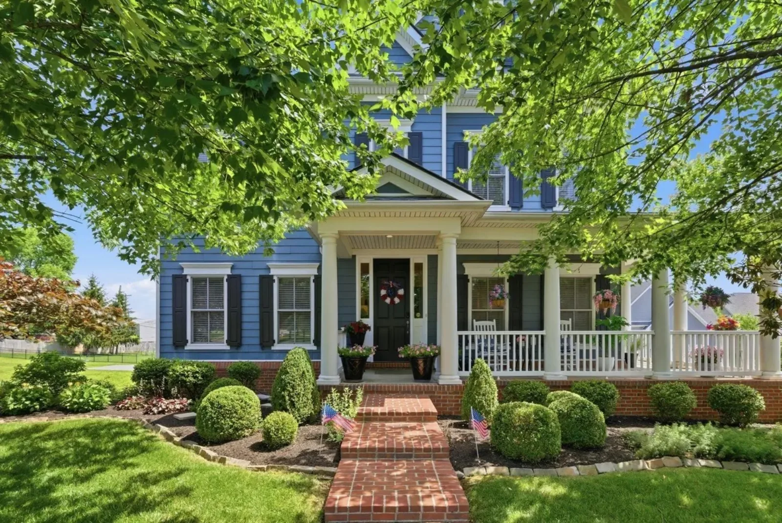 Blue two-story Lexington KY home with a covered front porch, a typical purchase where seller concessions cover closing costs