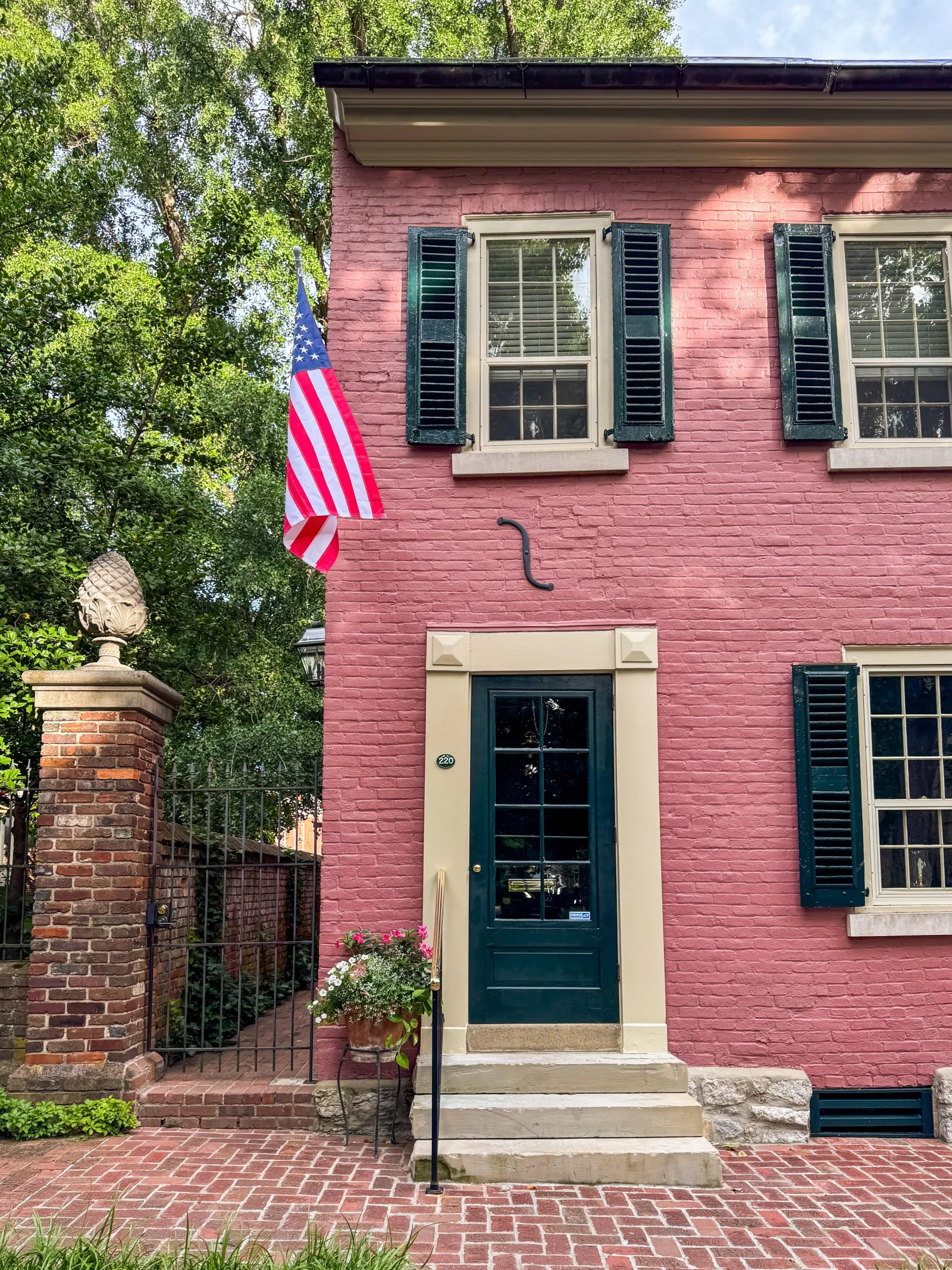 A welcoming pink-brick Lexington home with an American flag