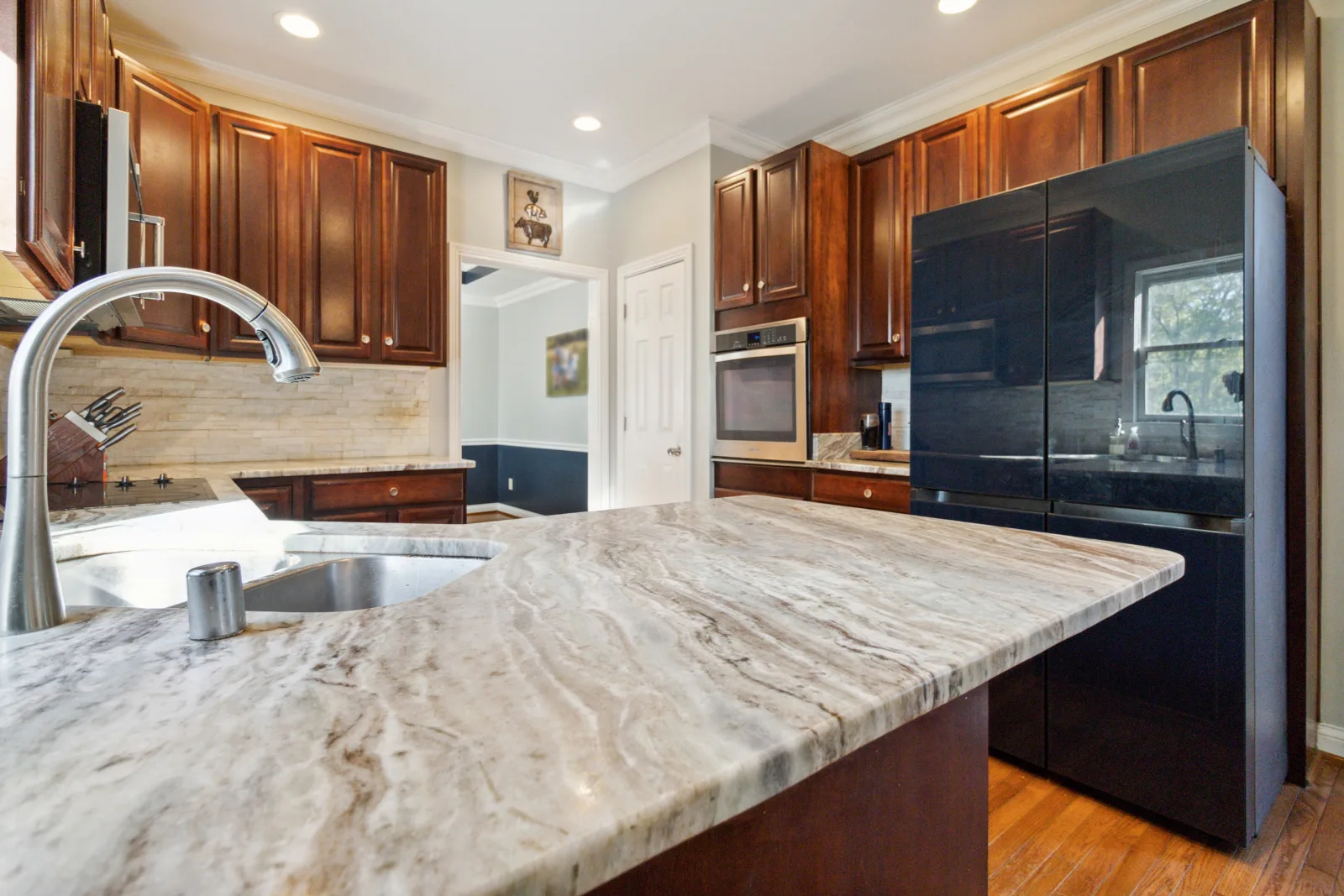 Clean Lexington kitchen with a marble island and clear countertops