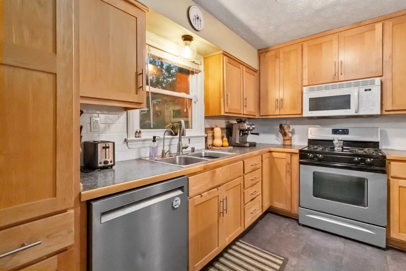A renovated maple-cabinet kitchen with stainless appliances in a Lexington KY home