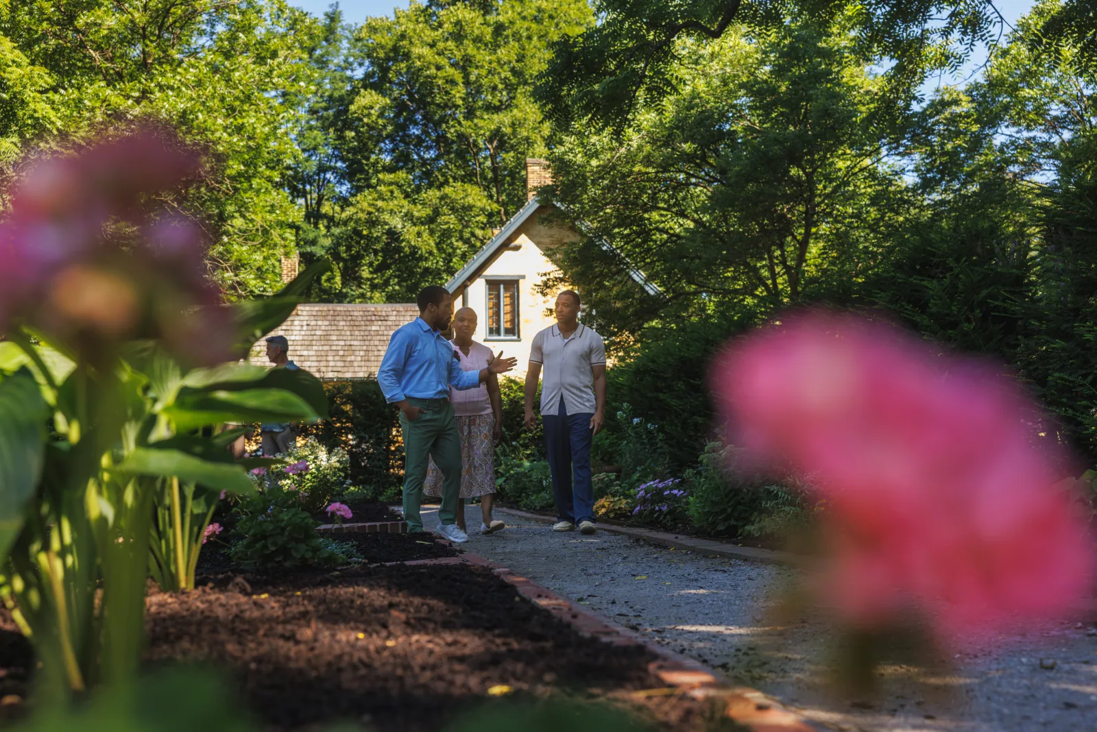 Neighbors talking on a garden path outside a historic Lexington home