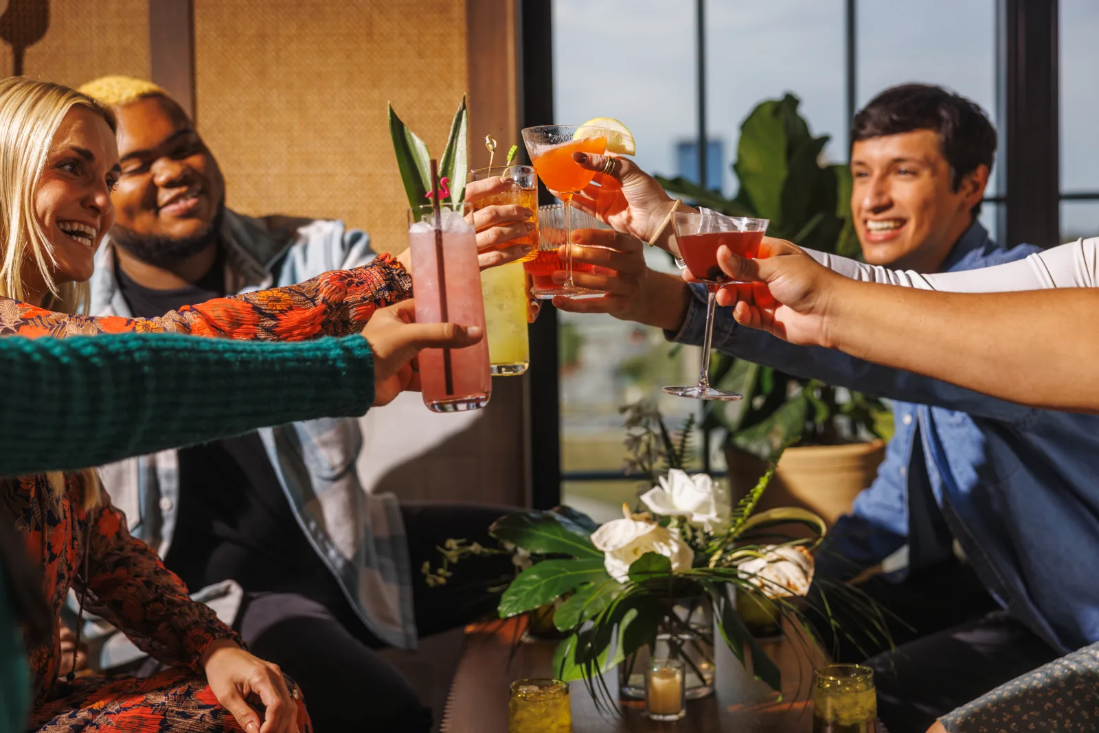 Friends toasting cocktails on a rooftop in downtown Lexington
