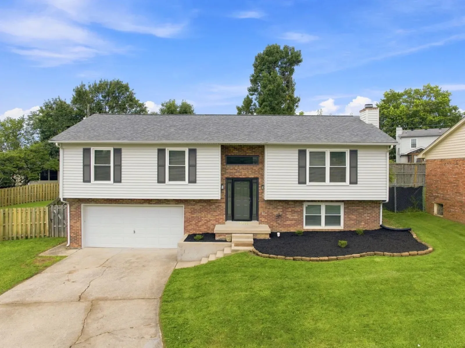 Renovated split-level home with a brick base and white siding in a Lexington KY neighborhood where VA buyers shop
