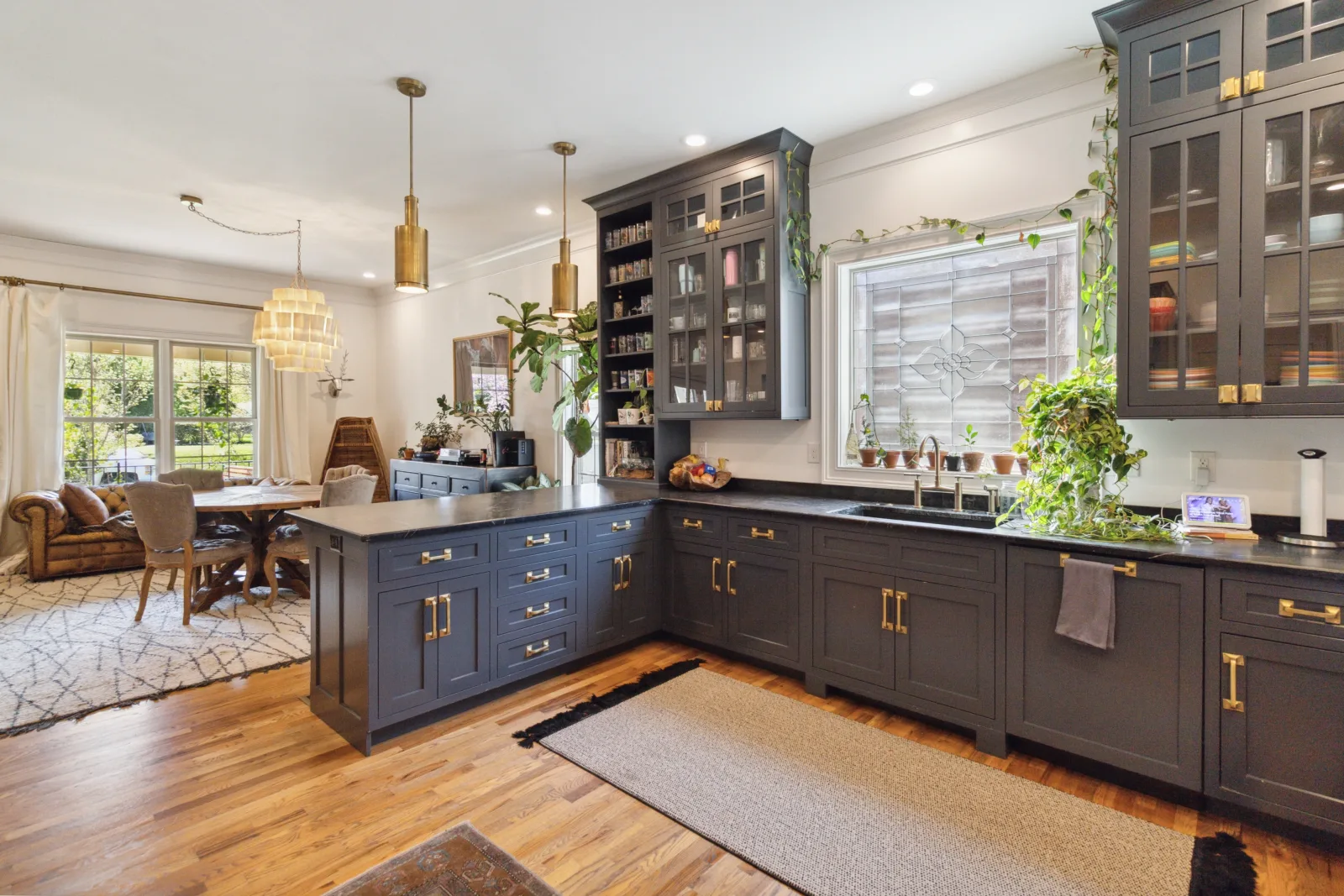 Custom kitchen with built-in navy cabinetry, glass-front cabinets, and hardwired pendant lighting in a Lexington KY home